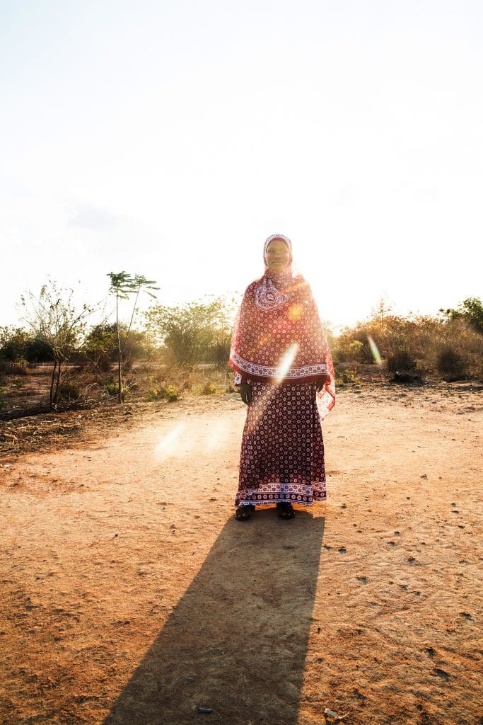A woman named Hanifa stands in front of the sunlight