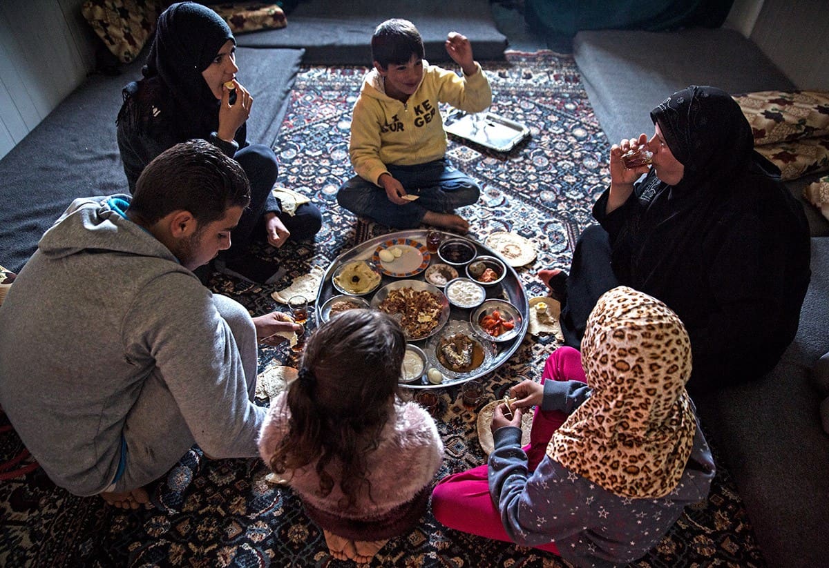 Marouf’s family enjoys a meal together after returning from the Tazweed market.
