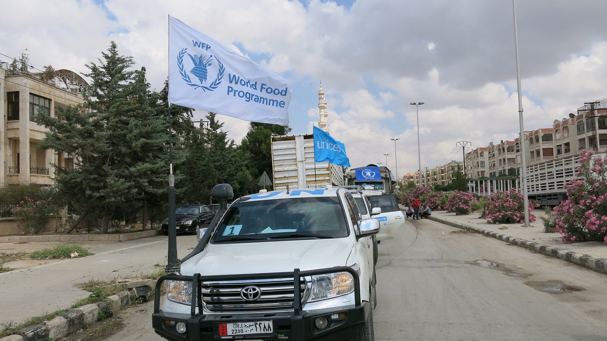 A convoy of trucks with WFP and UNICEF flags