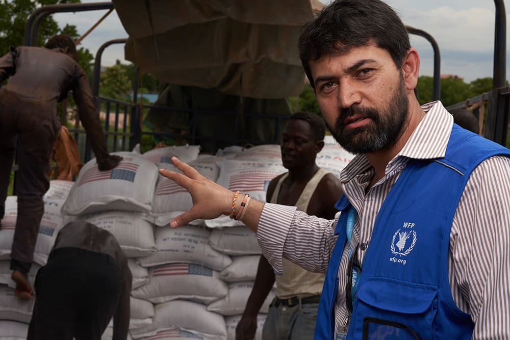 Adham Effendi, WFP's head of logistics in South Sudan, oversees food being transferred from trucks arriving in Juba from outside South Sudan to trucks transporting the food to various locations inside the country.