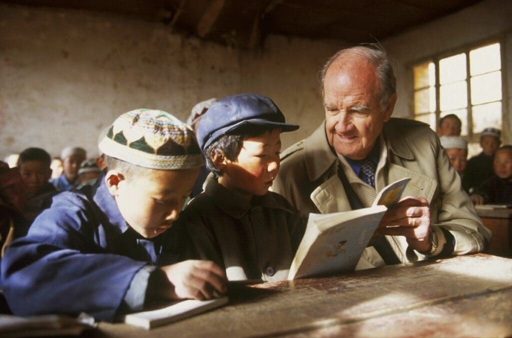 George McGovern reads with students in a rural Chinese primary school.