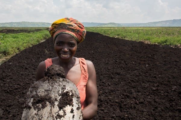 Farmer Clementine Uwamahoro stands in her field.