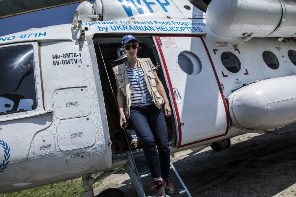 Lara Atanasijevic, WFP Access Officer, disembarks from an UNHAS helicopter in Katdalok.