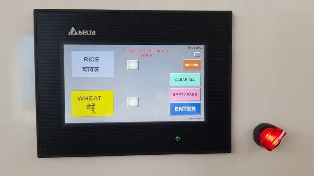 A small digital screen shows buttons that read: rice, wheat, clear all, empty pans and enter.