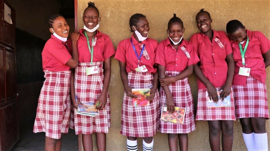 schoolgirls in red uniforms standing side by side