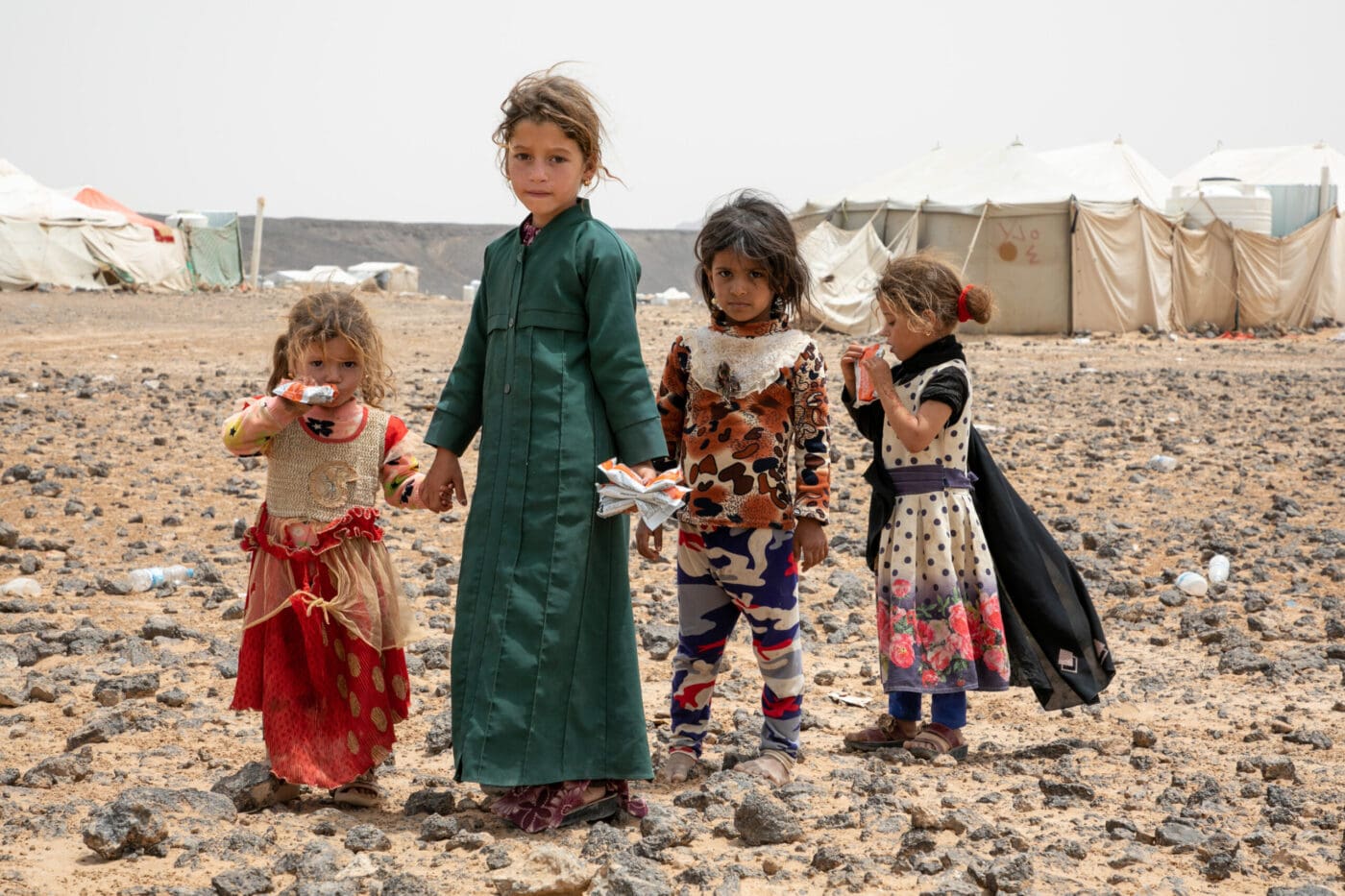 children standing in desert landscape