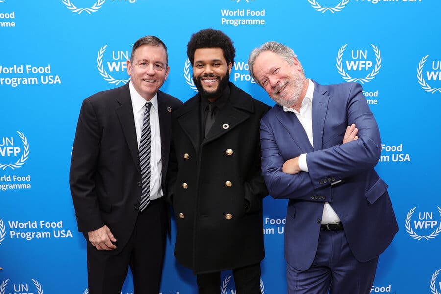 three men standing in front of WFP USA background