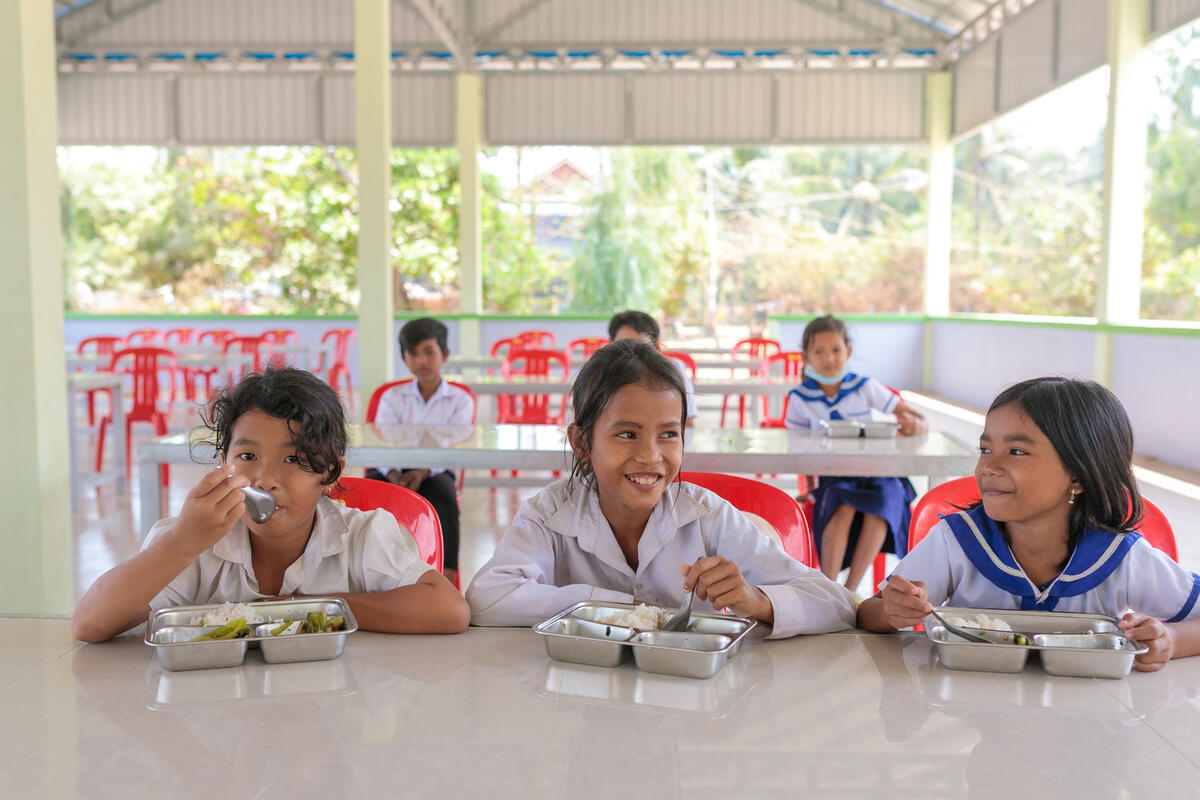 schoolgirls in white uniforms eating lunch