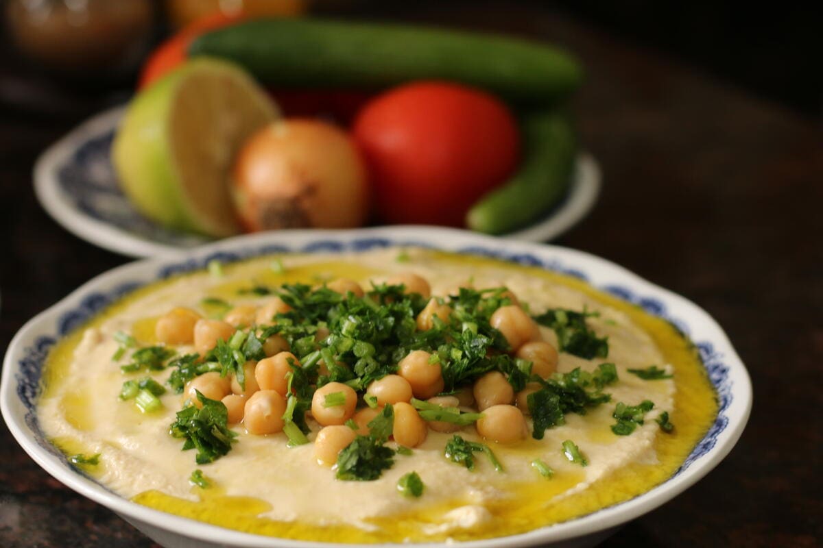 plate of hummus with chickpeas and vegetables