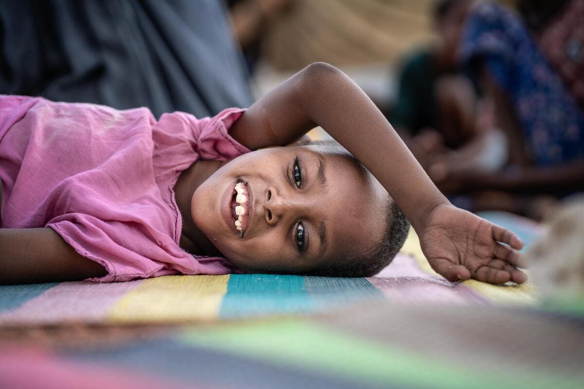 young girl on mat smiling