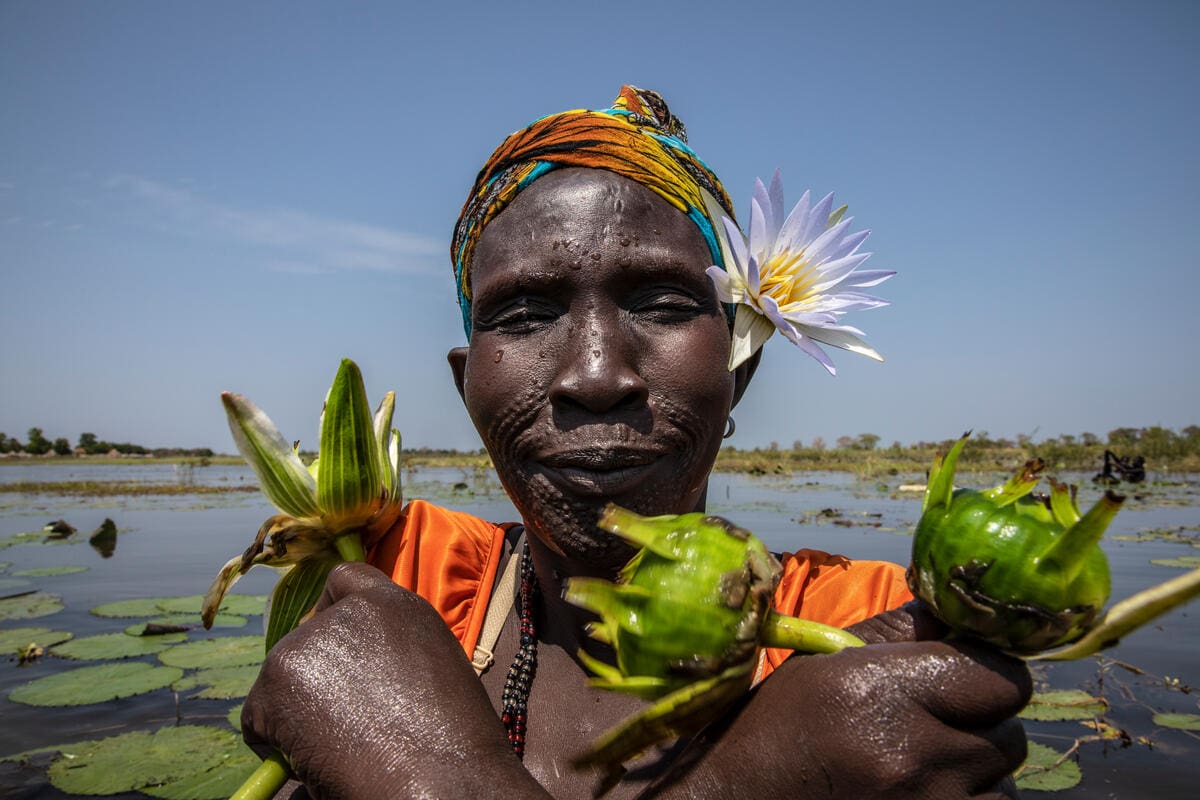 Woman holds lily bulbs in South Sudan