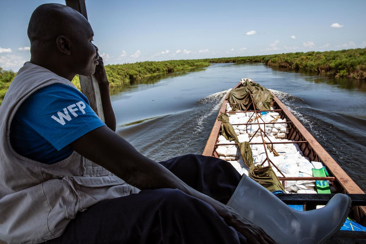WFP’s emergency team member Alex Korayi on boat in South Sudan