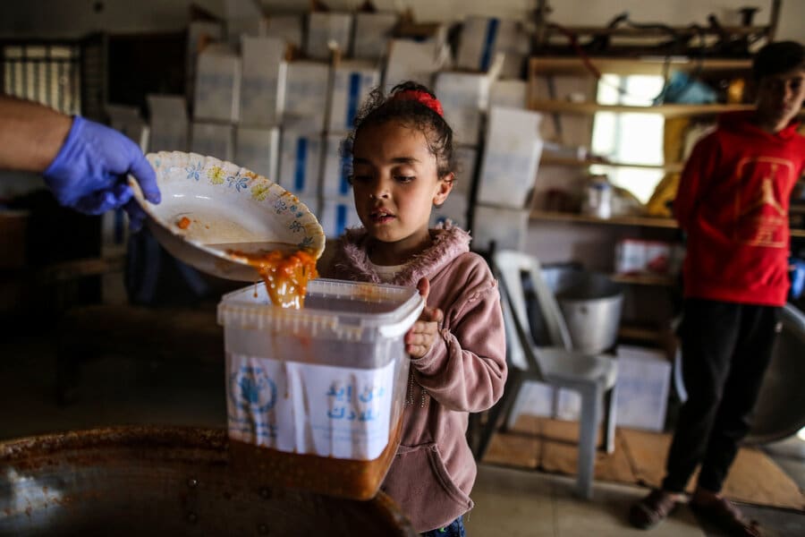 Girl receives food from WFP in Gaza