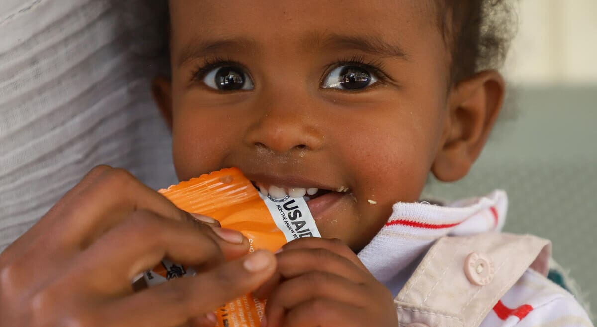 Child eats nutrition supplement in Ethiopia